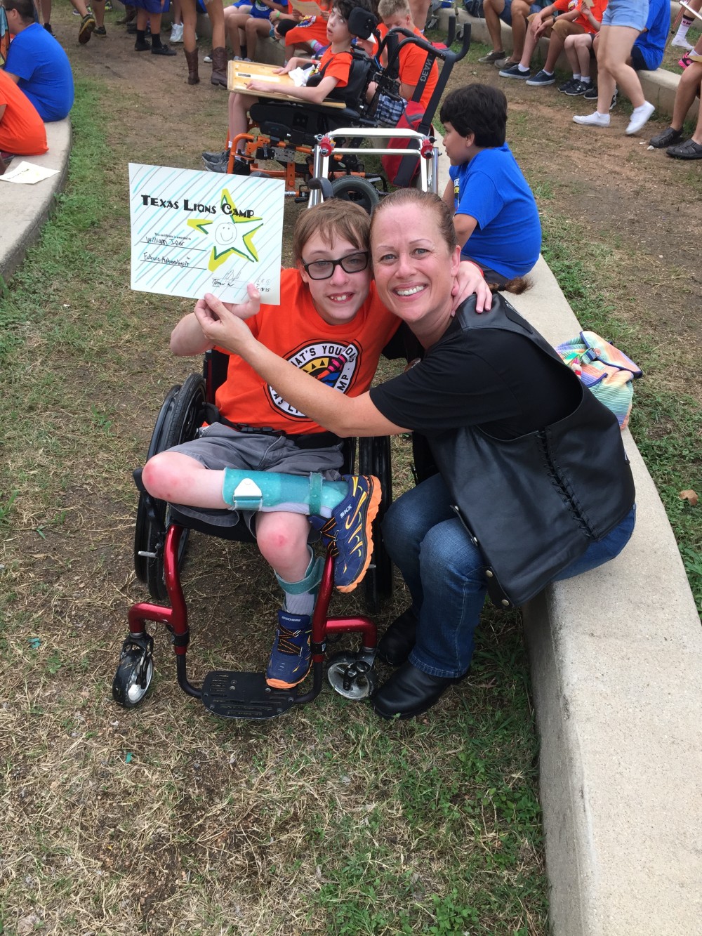 Jus-Madi with a camper at our donation check presentation during the 2015 Texas Lion’s Camp Run – June 2015 | San Jacinto High Rollers MC - Katy Chapter